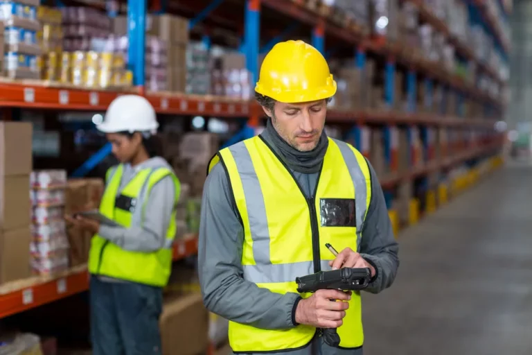 worker checking stock with digital equipment